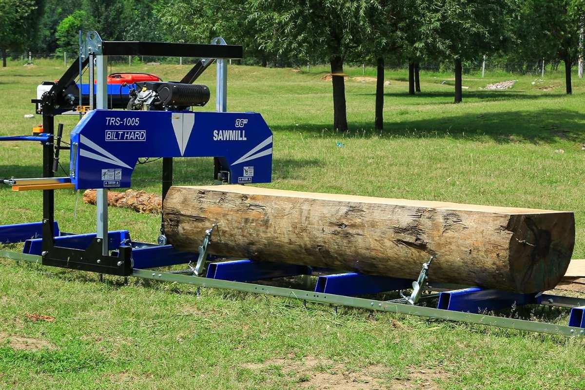 BILT HARD 36 inch portable sawmill with a long log in a grassy field