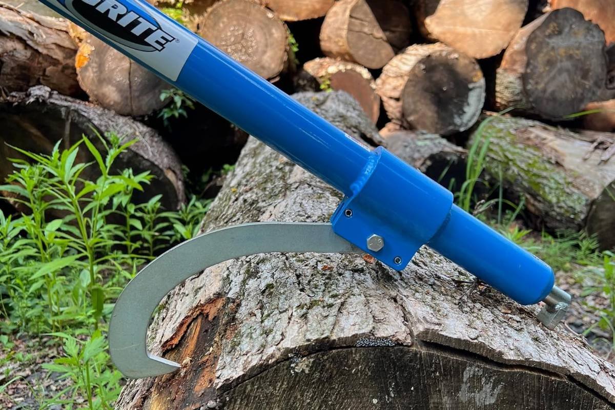 LogRite cant hook with its hook set on a log in front of a log pile