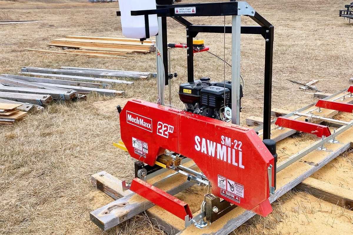 MechMaxx SM-22 portable sawmill on its track on a dirt lot