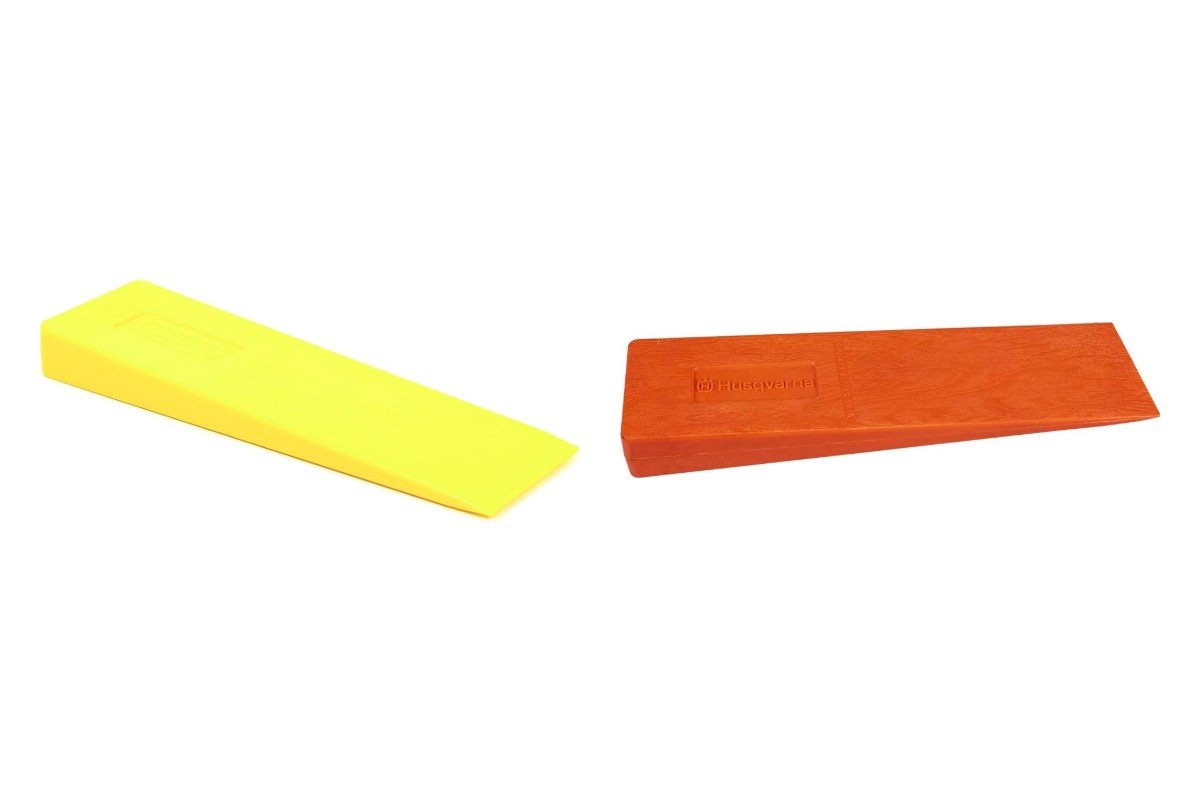 Yellow Oregon 5.5 inch felling wedge next to an orange Husqvarna 12 inch felling wedge