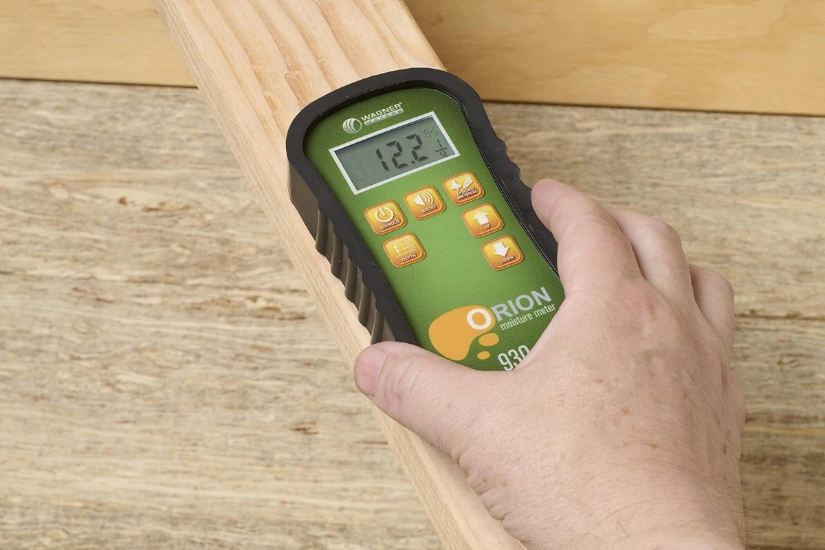 Wagner Orion 930 pinless moisture meter held flat on a pine board