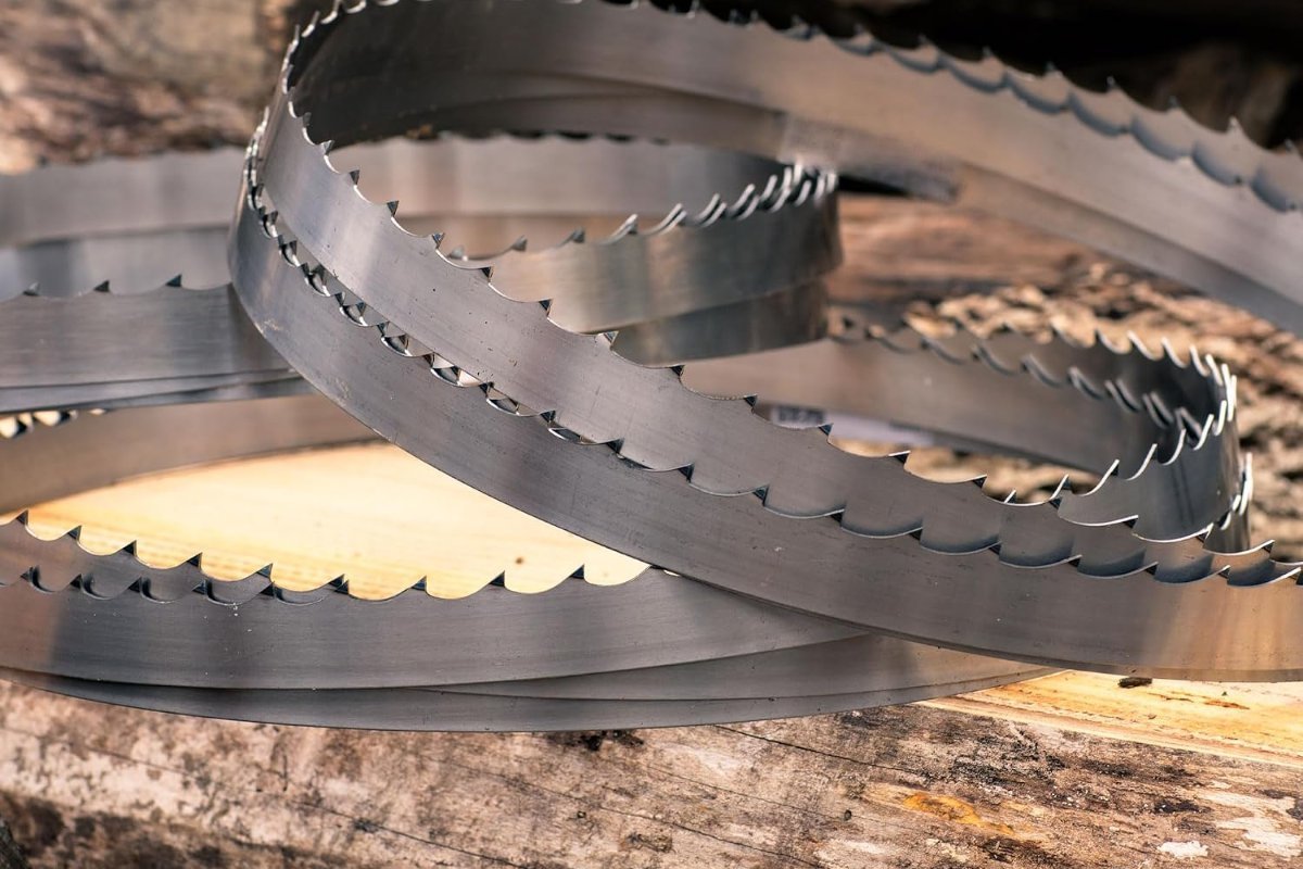 Coiled Wood-Mizer DoubleHard sawmill band blades resting on a log